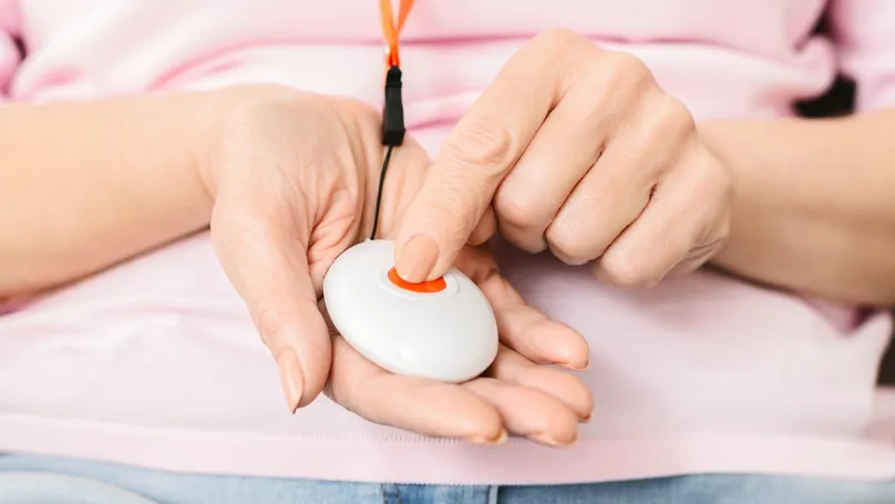 A woman pressing the alert button on her personal safety alarm.
