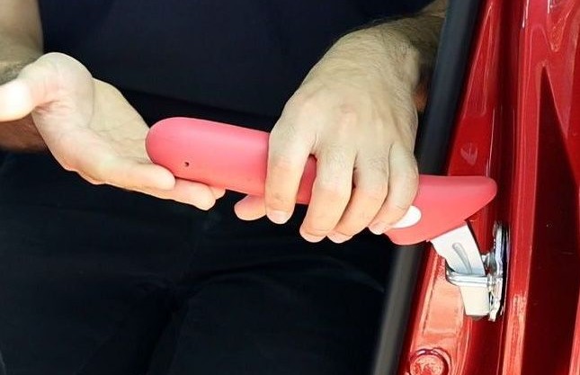 A close-up image of the car assist bar inserted into a car door.