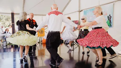 A group of people dancing in a circle.