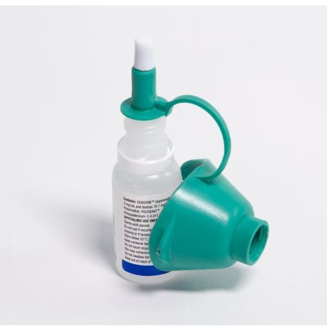 Eye drop dispenser attached to bottle.