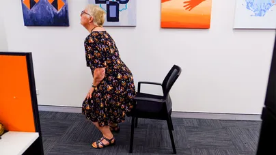 A woman getting up from her chair.