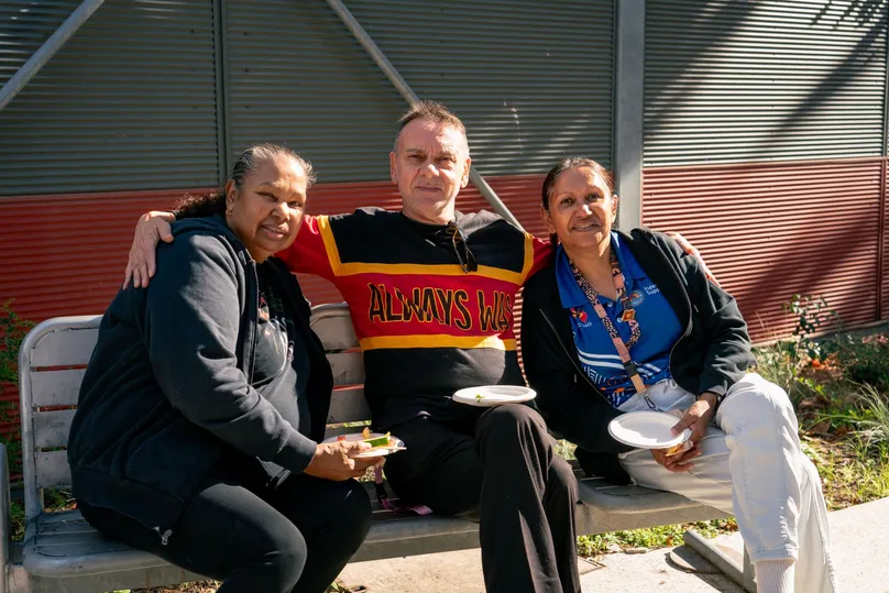 Three Aboriginal Health Workers at the LiveUp launch sitting on a bench