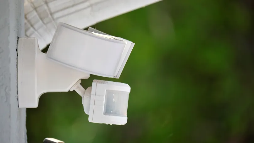 A motion sensor light mounted to an outside wall.