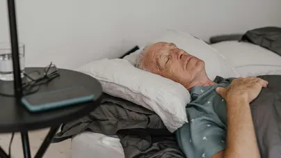 Older man sleeping in bed