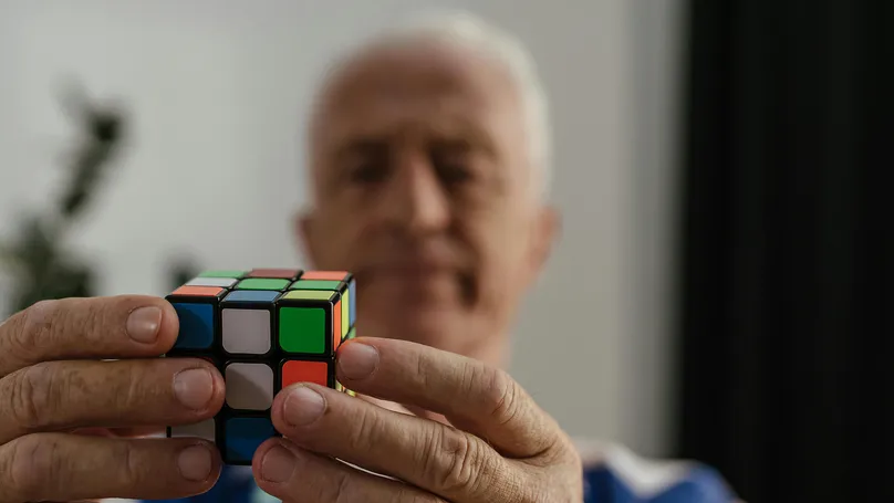 Older man solving a Rubick's Cube