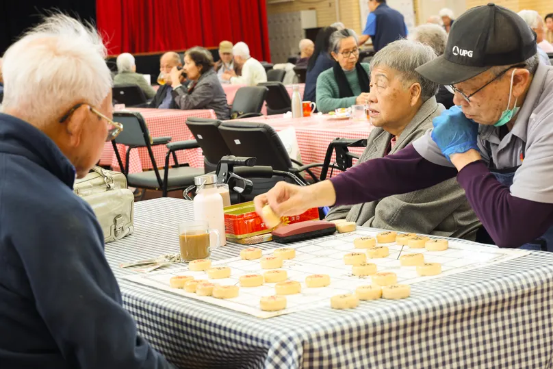 Older men playing board game