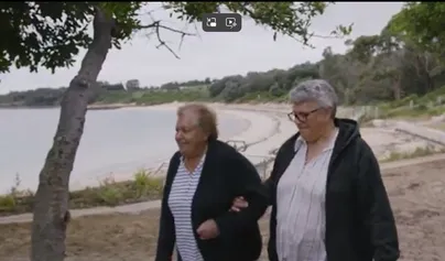Lorraine and Marjorie walk at the beach 
