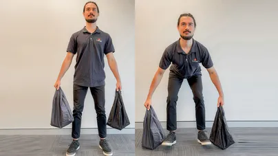 A man doing deadlifts with shopping bags.