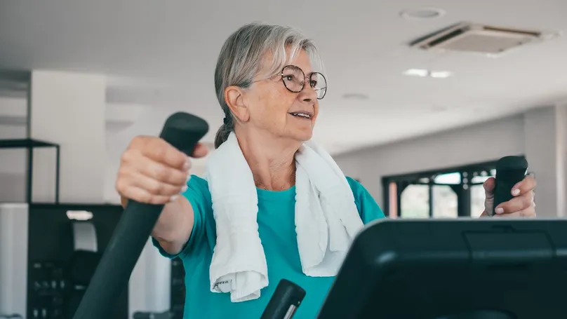 A woman using cardio stepper machine in the gym.