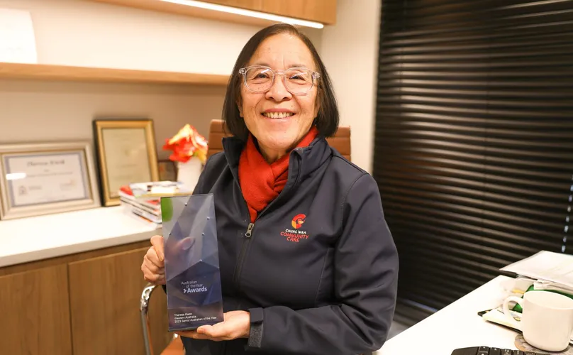 Theresa Kwok holding her West Australian Senior of the Year award and smiling at the camera.