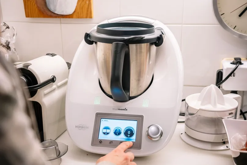 A Thermomix in a kitchen being turned on.