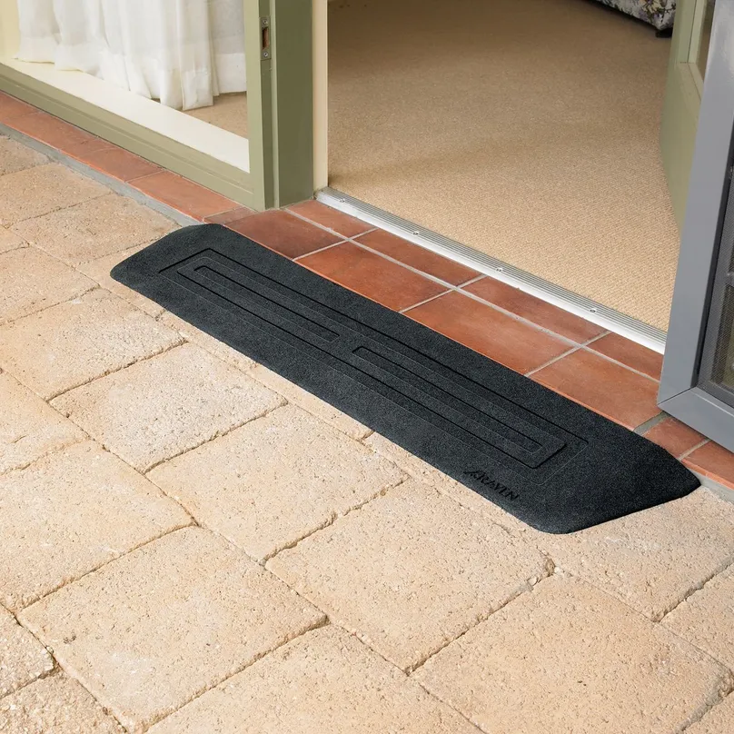 A small black ramp across a raised doorway lip.