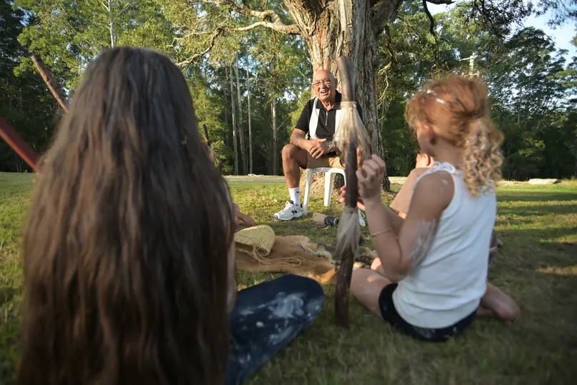 Uncle Victor Wright sits with his grandkids on Country to enjoy a yarn and make traditional artefacts. 