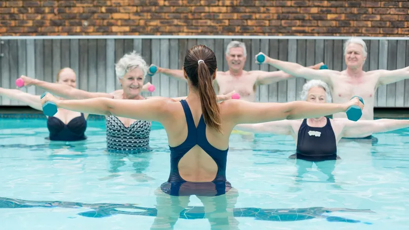 A group of older people enjoying a water aerobics class.