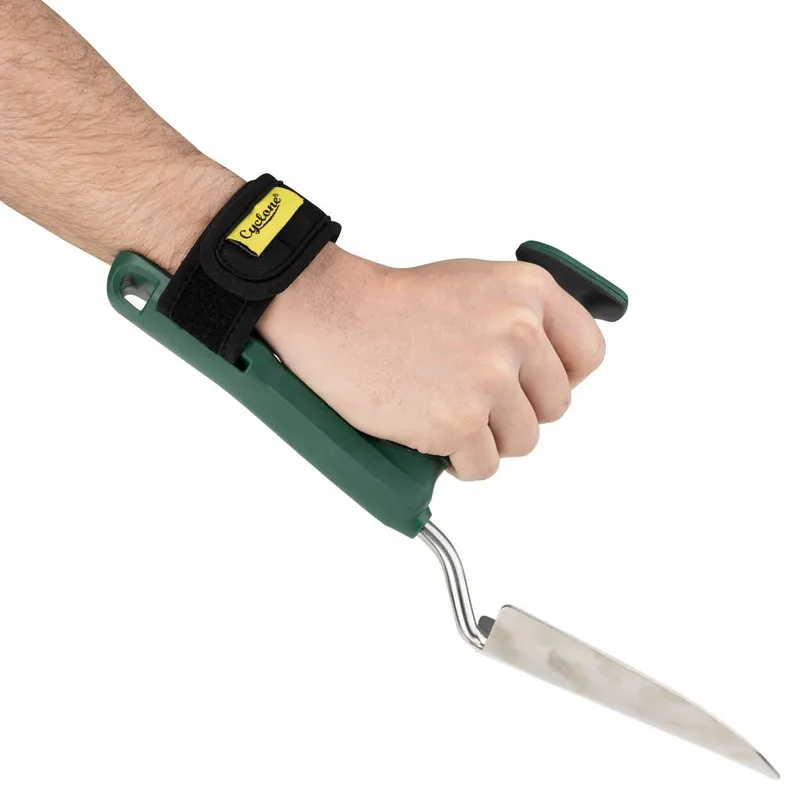A hand gripping an adaptive trowel. The tool has a perpendicular handle and strap for neutral wrist position and weak grip.