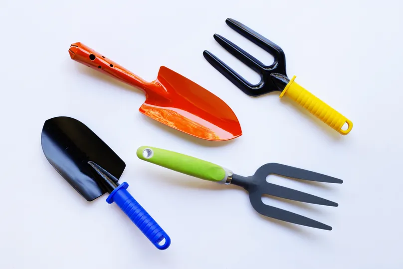 Small hand tools in bright neon colours of yellow, red, green, and blue.