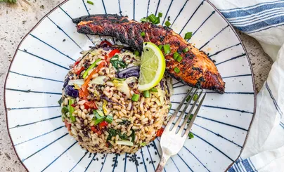 A delicious plate of miso ginger salmon with Asian veggies and quinoa.