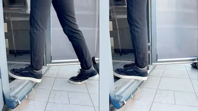 A man stepping up onto a doorstep.